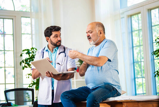 Indian Senior retired male patient undergoing physiotherapy assessment for shoulder, neck pain