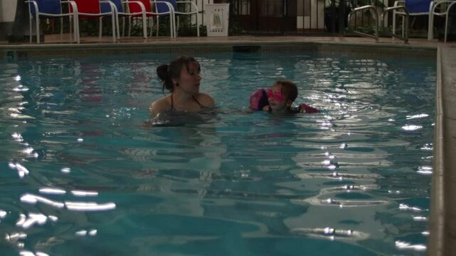 Mother Teaching Kid to Swim