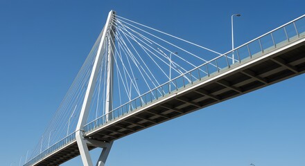 Modern twisting bridge with steel and glass design against blue sky