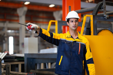communicate by walkie talkie transmitter, radio. Hispanic man worker in safety hardhat helmet at...