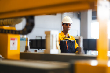 professional engineer worker working control sheet metal roof tile roll forming machine at metal sheet profiling factory. Industrial production. control panel button on manufacturing machine