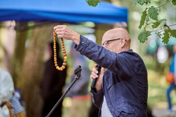 Outdoor lecture on amber jewellery with mature man