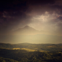 Fototapeta premium fantasy landscape with mountain peak over green hills