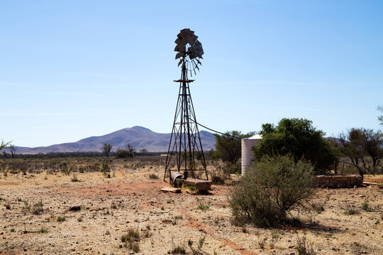 windmill and tank in dry landscape