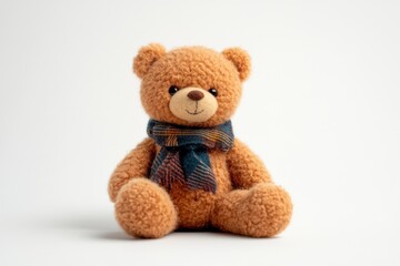 Soft and cuddly teddy bear carefully posed against a serene white background with a stylish scarf isolated on transparent background