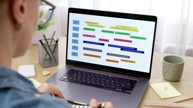 Woman looking at screen with calendar and dates. Concept of planning business meetings and events. Organization of time management.