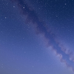 Obraz premium Cosmic Canvas: The Milky Way's Ethereal Dance in a Star-Kissed Sky