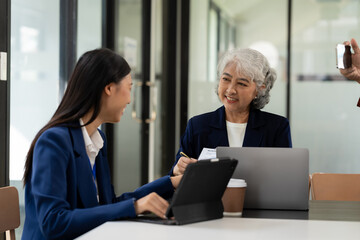 Asian business team working with analytical reports and consultants showing plans, financial analysis