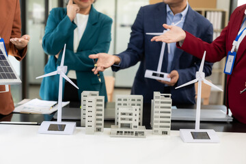 Team of engineers in factory office, presentation on ESG project planning, solar panels, wind turbine power generation, sustainable energy efficiency.