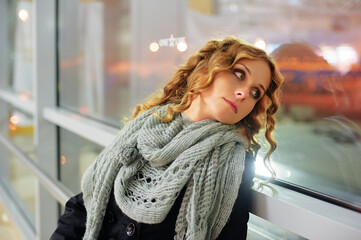 Contemplative Woman Sitting By A Window at Night..