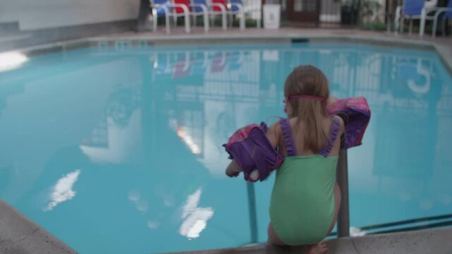 Cute Little Girl Trying to get into a Cold Swimming Pool
