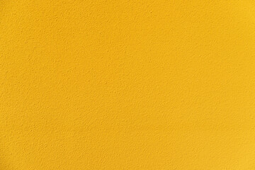 Cement textured yellow wall background texture