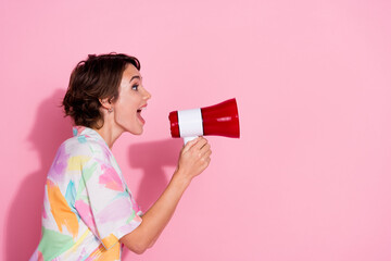 Profile photo of lovely young woman loudspeaker empty space wear shirt isolated on pink color...