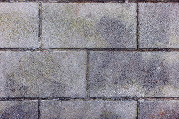The exterior walls of the building are decorated with grey brick walls