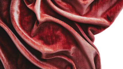 Close-up of rich red velvet fabric showcasing smooth texture and folds on a white isolated background.