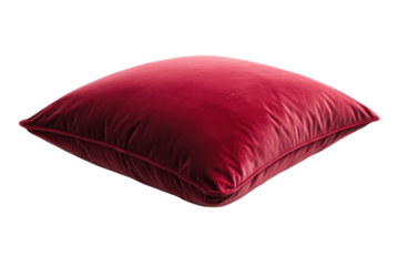 Luxurious deep red velvet cushion resting elegantly on a minimalist white surface in soft lighting isolated on transparent background