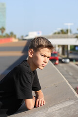 Fototapeta premium Handsome teenager standing with skateboard. Adolescent discovers city streets