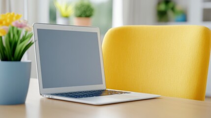 Fototapeta premium Minimalist Workspace Setup with Laptop and Vibrant Chair and Plant