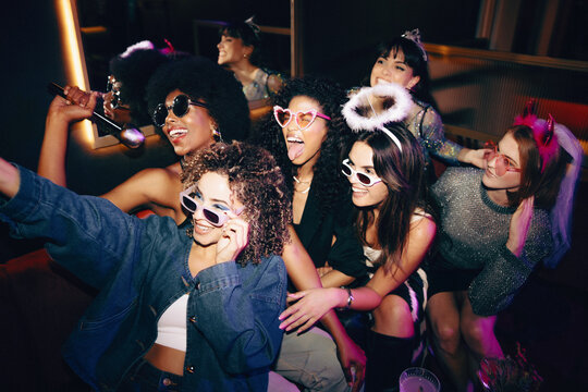 Group of joyful friends enjoying a lively night out together