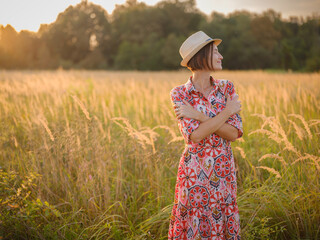 young woman embracing herself, self-love in action, mental health advocate, practicing self-care for finding inner peace, in European countryside