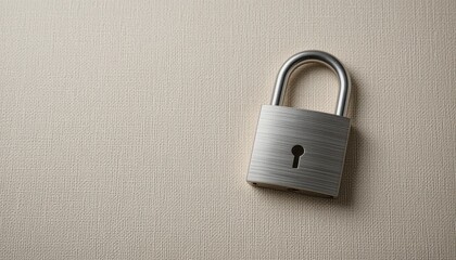 Durable padlock securely mounted on a wall highlighting security and protection in an outdoor urban environment