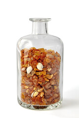 natural raw amber in glass bottle isolated on white background