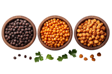 Three wooden bowls filled with assorted legumes: black, orange, and yellow varieties, surrounded by fresh herbs, isolated on a white background.