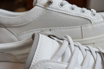 white sneaker with an elegant design high-quality stitching footwear shoe stores detail fashion lifestyle styling tips minimalist athleisure casual wear eco-friendly materials sportswear sustainable 