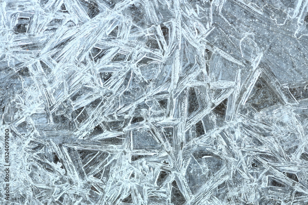 Poster a detailed view of intricate ice crystals formed on a surface, showcasing their delicate structures.