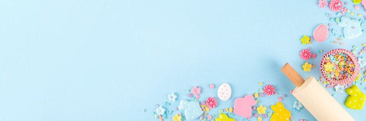 Easter baking background with sugar sprinkles, sugar Easter bunny, easter egg and spring flowers...