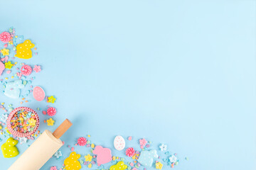 Easter baking background with sugar sprinkles, sugar Easter bunny, easter egg and spring flowers...