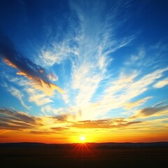 Naklejka premium A vibrant orange sunset with blue sky and cloud formations