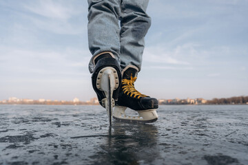 Showing sharp blade. Close up view of man that is on ice with skates in winter