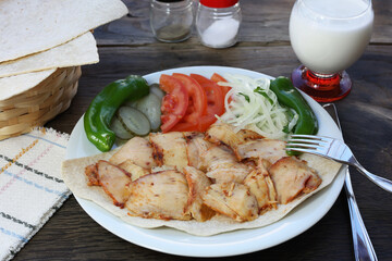 Tavuk Döner - Turkish Chicken Doner Kebap with garni on the wood