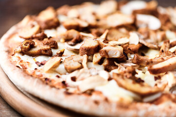Gyros Pizza with with champignons and mozzarella cheese. Wooden background. Soft focus.