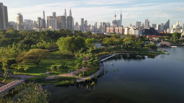 kuala lumpur park sunrise sun with blue lake and pedestrian jog
