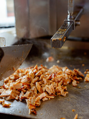 Making Shawarma: Cutting grilled meat