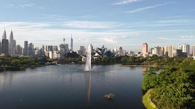 kuala lumpur park sunrise sun with blue lake and pedestrian jog