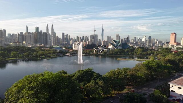kuala lumpur park sunrise sun with blue lake and pedestrian jog