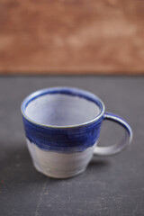 Ceramic cup on rustic background