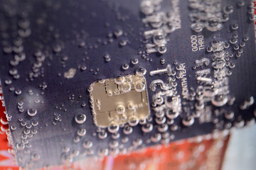 Water Splashing on Credit Card with Bubbles and Textured Background