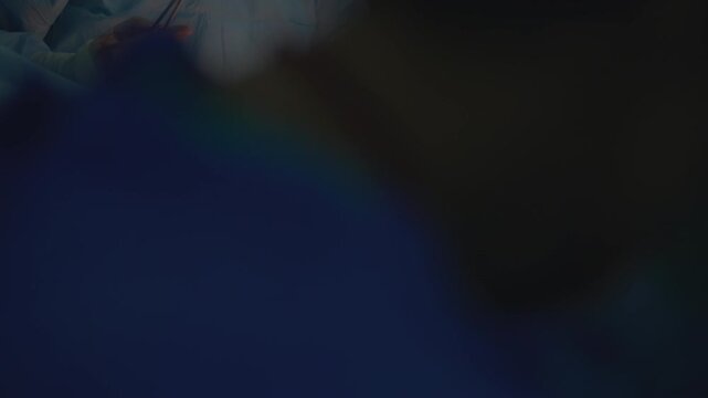 A surgeon carefully stitches the incision on a woman's belly during the final stage of a cesarean section operation. A precise medical procedure highlighting expertise, maternal care, and the