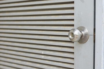 This door design, with its horizontal slats and round metallic doorknob, combines simplicity and functionality.