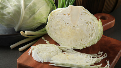 Beautiful juicy green cabbage on a light table, in rustic style, kitchen. top view overhead view...
