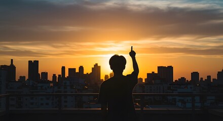 Plakat Silhouette of a person enjoying sunset over city skyline golden hour urban view art dark mood night