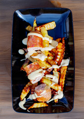 Appetizing street fast food: sausages with French fries 