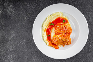 Fish in tomato sauce and mashed potatoes tasty fresh delicious gourmet food background table rustic food top view copy space