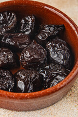 Dried prunes smoked drained plum gourmet food background on the table rustic food top view copy space keto and paleo diet vegetarian and vegan food