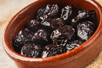 Dried prunes smoked drained plum gourmet food background on the table rustic food top view copy space keto and paleo diet vegetarian and vegan food