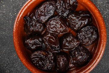 Dried prunes smoked drained plum gourmet food background on the table rustic food top view copy...
